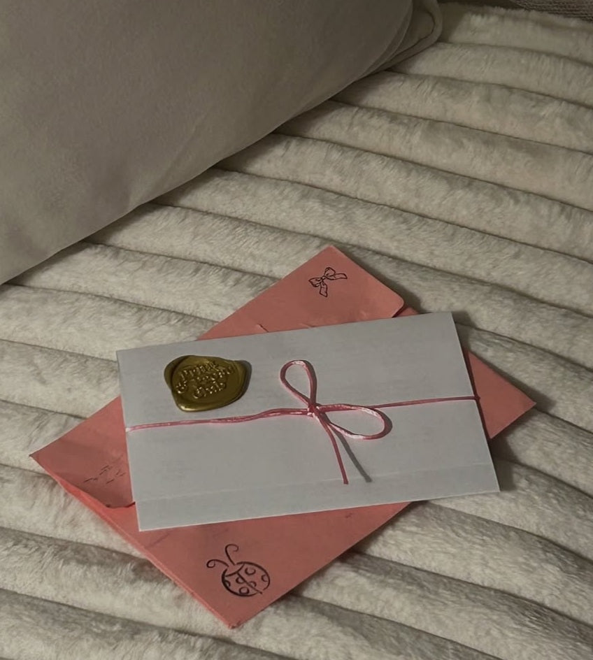 Decorative envelopes with ribbons and seals on a textured surface